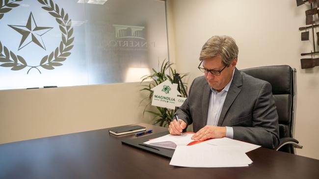 Dr. Brent Wilson Signing Land Purchase Agreement